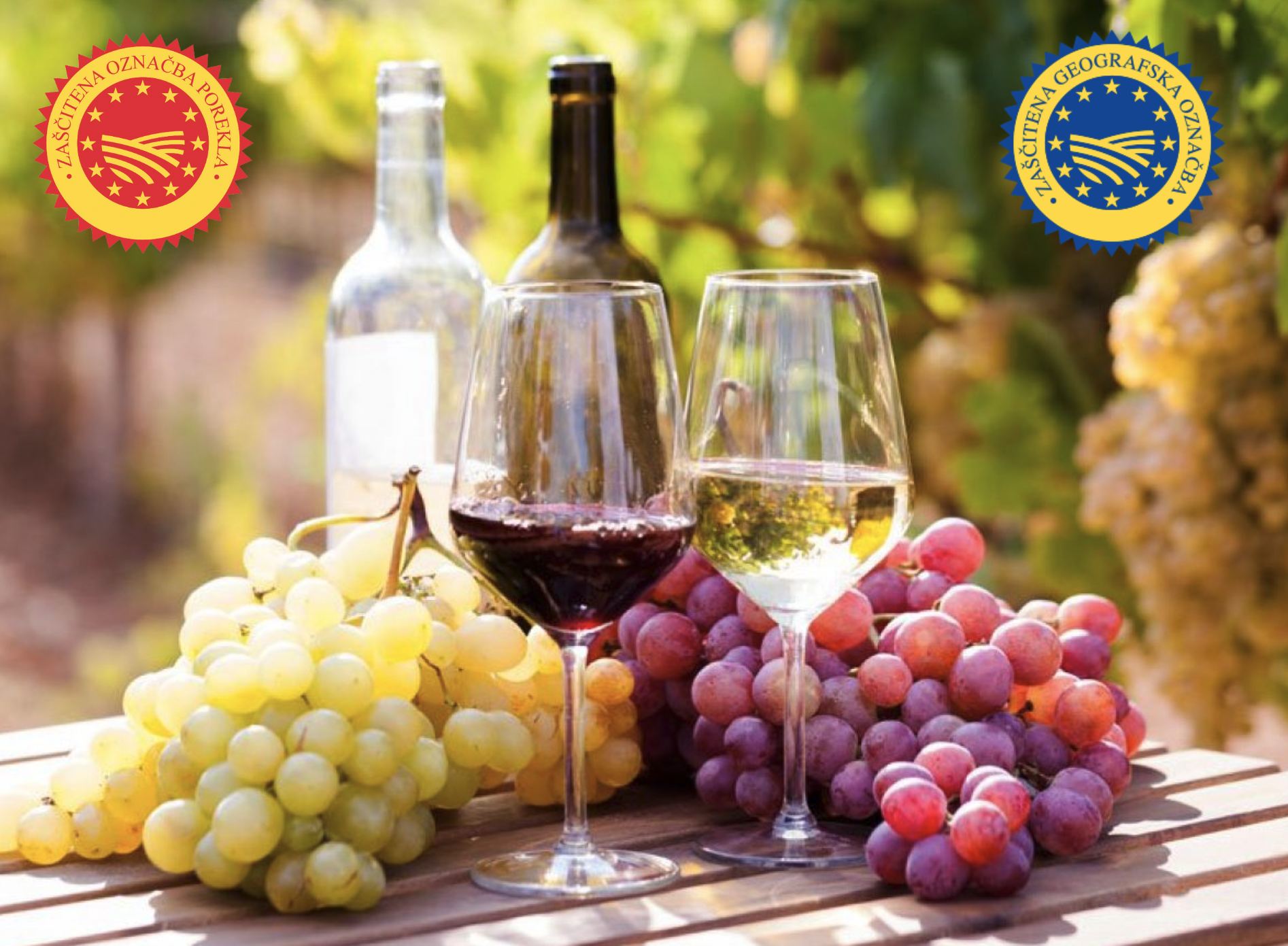 Steklenica vina, kozarci in grozdje